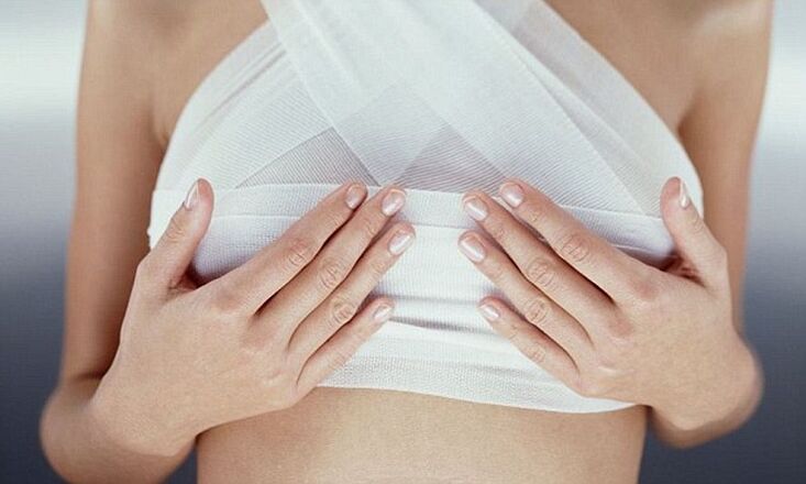 bandaged breasts after breast augmentation operation